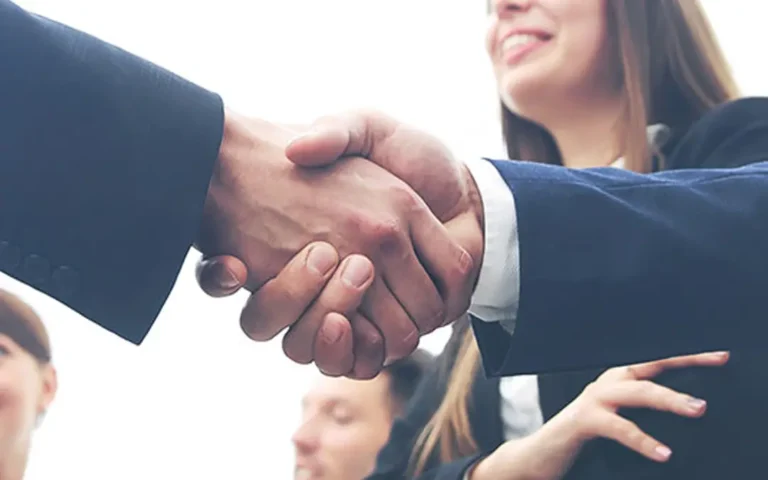 B.C. Ruling Regarding Extension of Benefits for Disabled Employees | Two executives shaking hands - Benefits Alliance