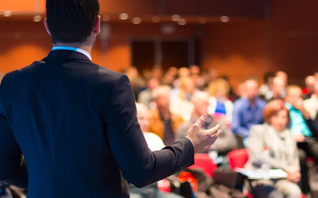 Summary of Bill 148- Changes to Employment Standards Act, 2000 | Person talking to an audience - Benefits Alliance