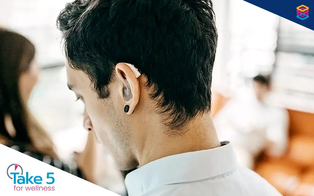 Make communications accessible for all | Young man with hearing aids on - Benefits Alliance