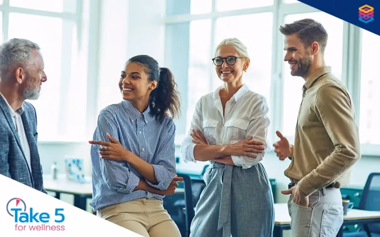 Doing good by doing wellness right | A group of coworkers from different age groups chatting with each other - Benefits Alliance